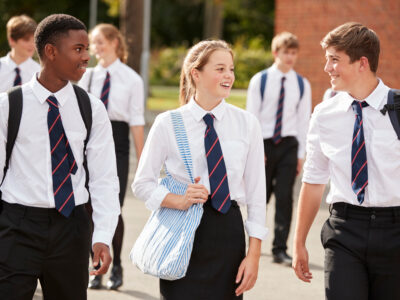 Group,of,teenage,students,in,uniform,outside,school,buildings